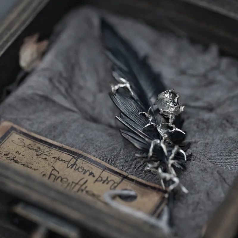 sylus black feather brooch